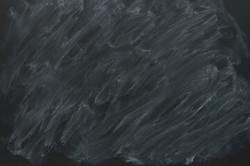 Obraz premium Dirty black chalkboard as background. School equipment