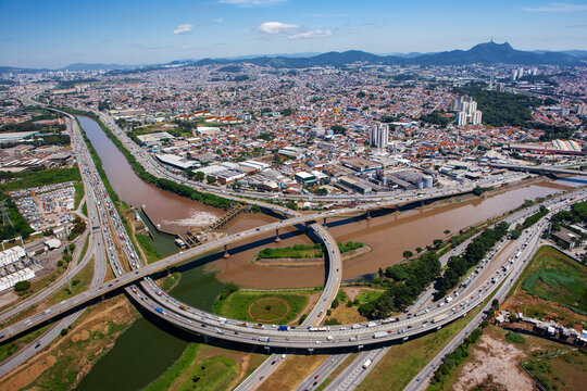 2016 JAN, S&Atilde;O PAULO City, BRAZIL, Aerial photo of Rodovia Castelo Branco with the marginal tiete and pine trees, Pico do Jaragu&aacute; in the background. Green Pinheiros River and brown Tiet&ecirc; River
