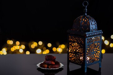 Lantern and dates fruit on dark backgrond with bokeh light for the Muslim feast of the holy month...