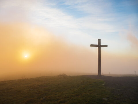 A cross at a scenic sunset or sunrise