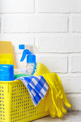 Household goods, equipment for cleaning and housework on the background with copy space. Supplies of sponges for washing, floor cloths, napkins, rubber gloves, bottles for spraying household chemicals
