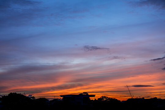 Dramatic sunrise sky with clouds. Dramatic sunrise over the village Bangkok.