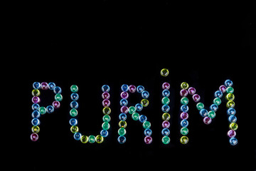 Text purim on black background for Jewish holiday