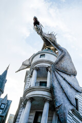 Fototapeta premium Orlando, USA – May 30, 2017: The Dragon at the Gringotts Bank in Diagon Alley at The Wizarding World Of Harry Potter in Universal Studio Orlando. Universal Studio Orland is a theme park in Orlando.