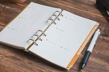 close up planner book on wooden table