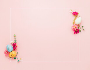 Easter holiday pink mockup background. Top view from above to different colorful Easter eggs, flowers, picture frame border. Card with copy space to place text. Minimal flat lay. High quality photo