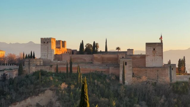 Panoramic view of the Alhambra citadel during sunset light with the Sierra Nevada in the background.