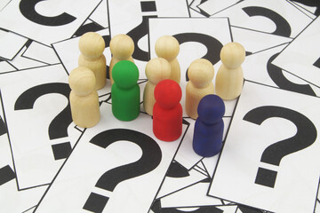 People figures on many question marks close up.