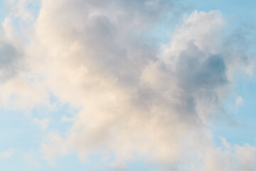 Background of blue sky with white pink clouds at sunset