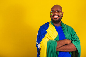 handsome afro brazilian man wearing glasses, brazilian fan, brazil, world cup 2022, arms crossed,...