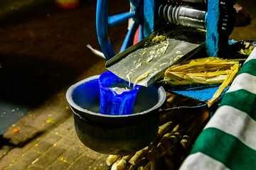 Preparing sugarcane juice at the Forodhani gardens in Stone town at night. Zanzibar, Tanzania