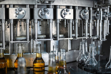 Automatic production line fills glass bottles with cognac