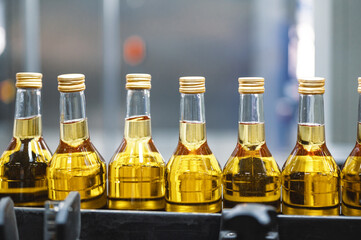 Alcohol liquor closed bottles with caps at production line