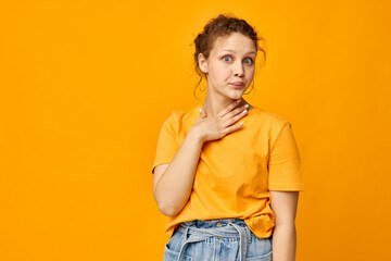 portrait of a young woman fun earrings grimace hand gesture Youth style yellow background unaltered
