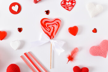 Background with lollipop and red accessories for a festive Valentine's Day. Banner for February 14. Valentine's Day greeting card. Space for copying. Flat position, top view