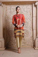 Fototapeta na wymiar A Pakistani shalwar kameez suit with dupatta. Pakistani model is shown her dress with style.