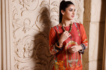 A Pakistani shalwar kameez suit with dupatta. Pakistani model is shown her dress with style.