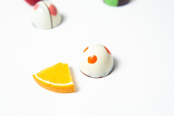 mexican Colorful chocolate candy bonbons with fruits orange, lemon and strawberries on white background in Mexico city
