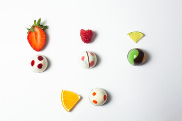 mexican Colorful chocolate candy bonbons with fruits orange, lemon and strawberries on white background in Mexico city