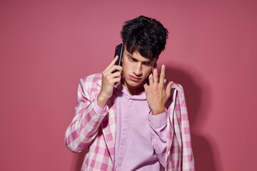 handsome guy with a phone in hand pink blazer fashion elegant style model studio