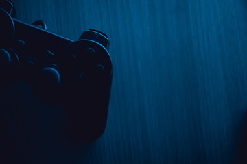gamepad lies on the table in the dark with blue backlight © Gregory