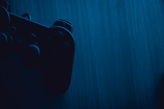 gamepad lies on the table in the dark with blue backlight