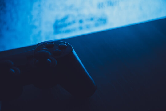 gamepad lies on the table in the dark with blue backlight