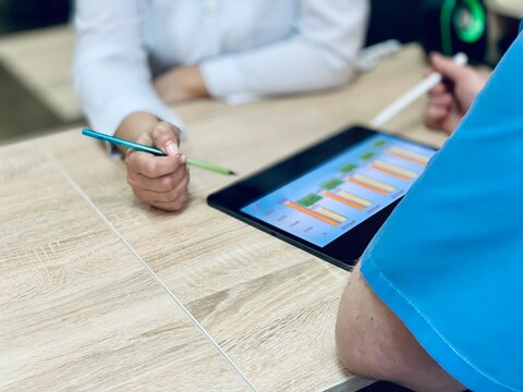 doctor analyzing healthcare stats report on digital tablet