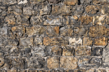 The texture of an antique stone wall from the 4th century BC in the city of Tongeren. Belgium