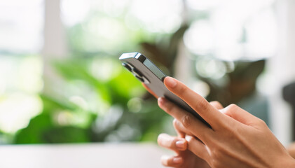 Hand holding smartphone and chatting online on mobile, During leisure time.
