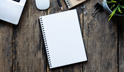 empty notebook with coffee and computer on wooden table ,top view