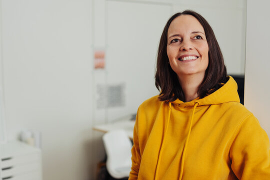 Casual middle-aged woman in yellow hoodie