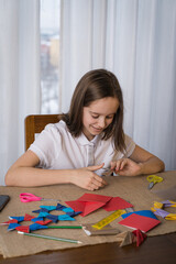 a beautiful teenage girl makes origami