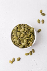 Pumpkin seeds in a bowl, superfoods. Copy space