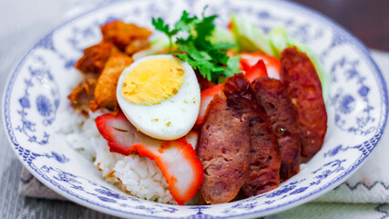 Rice with Red Roast Pork Served Boiled Egg and topped with Sweet Sauce.
