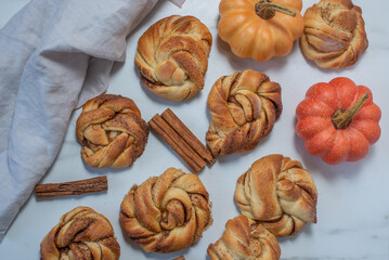 Sweet home made pumpkin cinnamon rolls on a table
