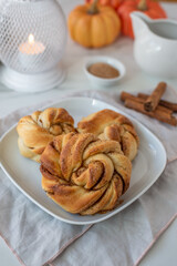 Sweet home made pumpkin cinnamon rolls on a table