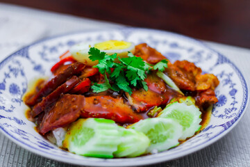 Rice with Red Roast Pork Served Boiled Egg and topped with Sweet Sauce.