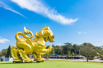Chiang Rai, Thailand - January, 11, 2022 : Golden Singha state on blue sky background at Singha park Chiangrai Thailand.