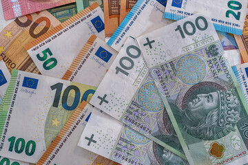 Stack of polish zloty and euro money as finance background