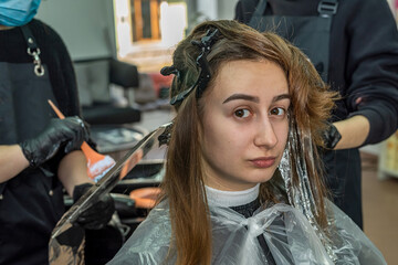 beautiful young client came to the salon to dye her hair.