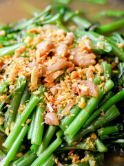 Stir-fried morning glory in a black dish 