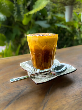Egg Coffee served in a timber hut restaurant Phuket Thailand. The coffee flavours and texture is so delicious a must coffee to try 