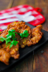 Corn Fritters With chili sauce placed on a wooden table