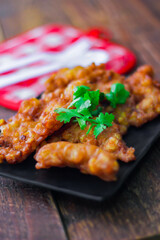 Corn Fritters With chili sauce placed on a wooden table