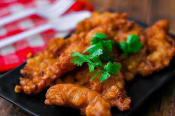 Corn Fritters With chili sauce placed on a wooden table