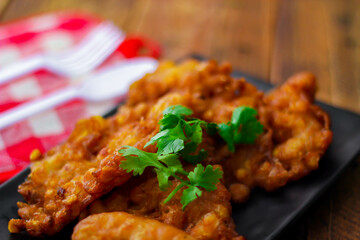 Corn Fritters With chili sauce placed on a wooden table