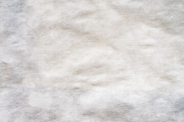 Texture of old crumpled covering garden material - spunbond for background and design