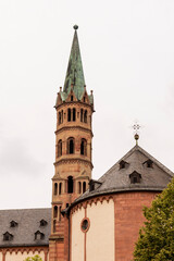 Fototapeta premium Brick colored towers with bronze green roofs at Würzburger Cathedral or Würzburger Dom and the apse roof seen from the presbitery side