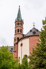 Fototapeta na wymiar Brick colored towers with bronze green roofs at Würzburger Cathedral or Würzburger Dom and the apse roof seen from the presbitery side